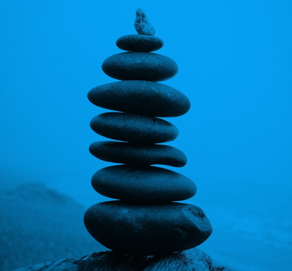 A tower of carefully-placed round stones with a blue color