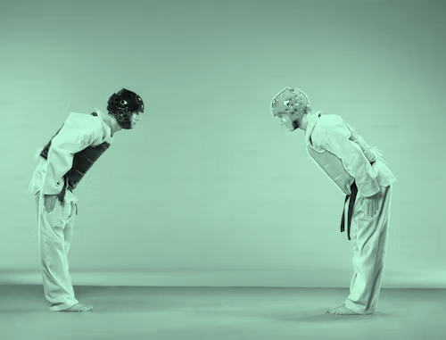  Two Martial Artists Paying Respect by Bowing to One Another Before Match