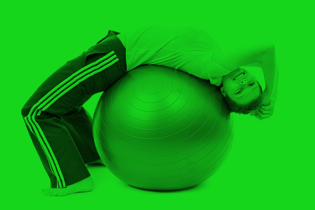 boy stretching on yoga ball