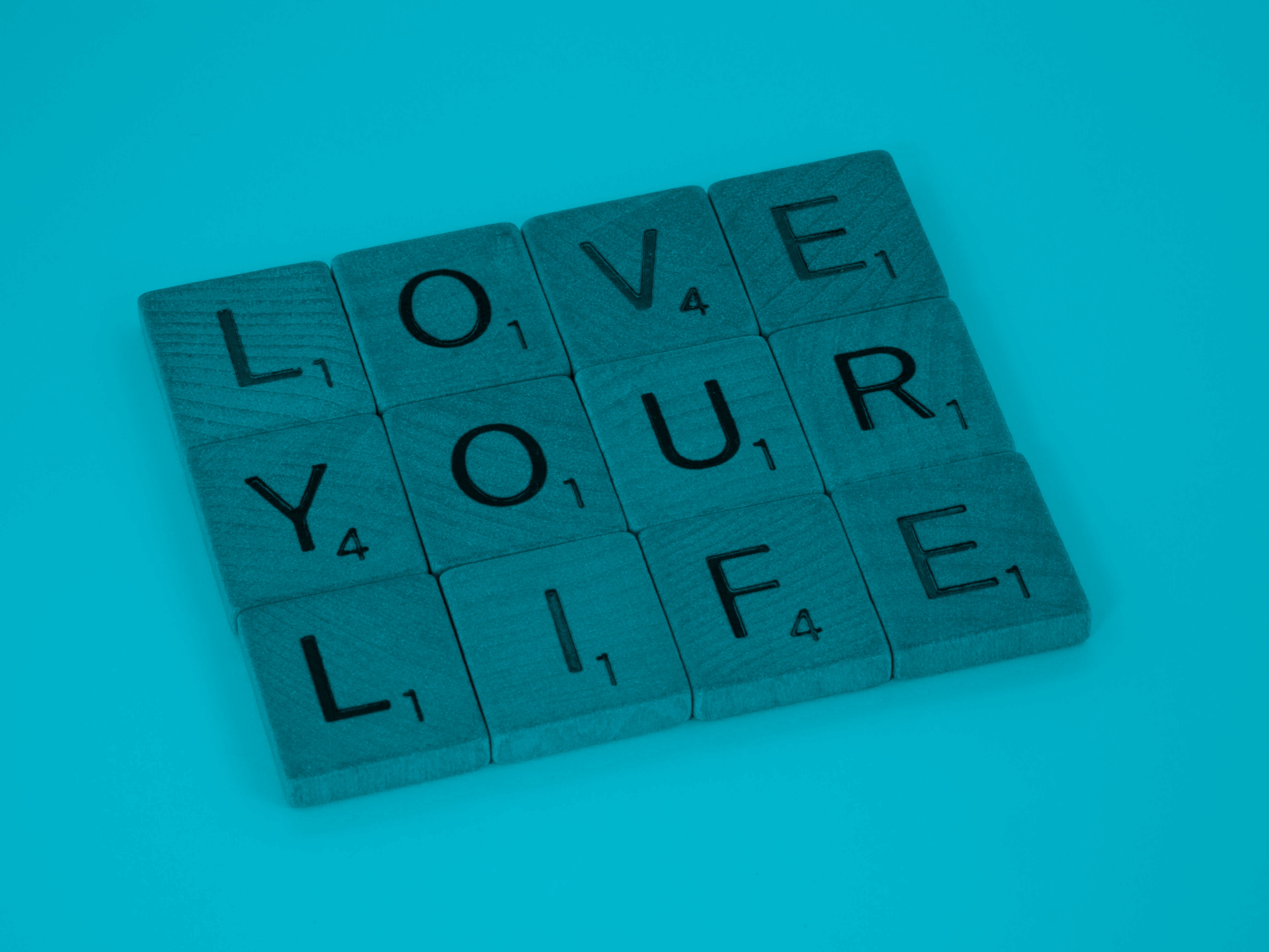 Scrabble tiles spelling out 'Love Your Life'