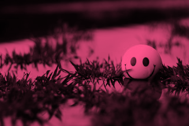  Ball with a smiley face on it sitting in water